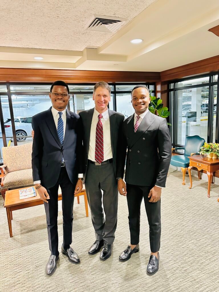 David Muanda and Lievin Kasaka pose for a picture with Carl B. Cook, President of the Presidency of the Seventy for The Church of Jesus Christ of Latter-day Saints, at the Church Office Administration Building, downtown Salt Lake City, Utah.